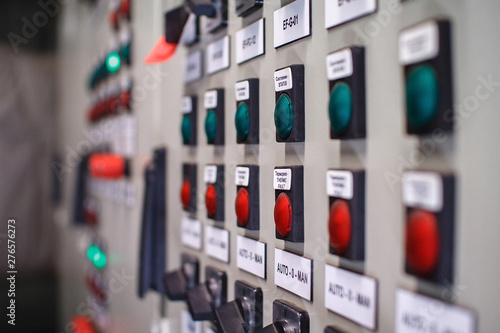 Control panel of temperature control units, selective focus. Many buttons are red and green.