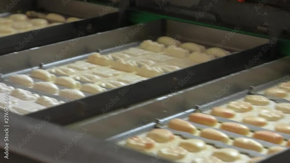 Production of chocolate candies. machine make delicious chocolate candies. Sweets production at the factory. White Chocolate. Pouring melted liquid premium milk white chocolate. Production of chocolate candies. machine make delicious chocolate candies. Sweets production at the factory. White Chocolate. Pouring melted liquid premium milk white chocolate.