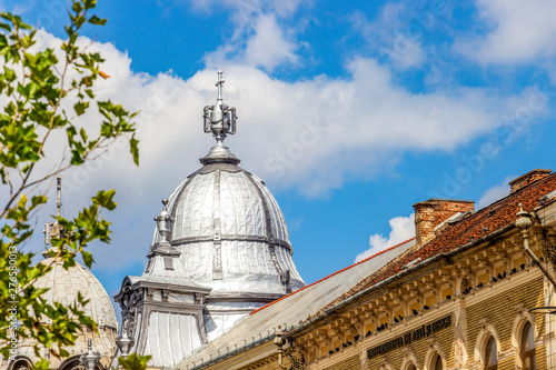 Details of beautiful old buildings at Piata Unirii, Unirii Square or Iuliu Maniu Street in Cluj-Napoca, Transylvania, Romania, Twin buildings architectural ensemble photo