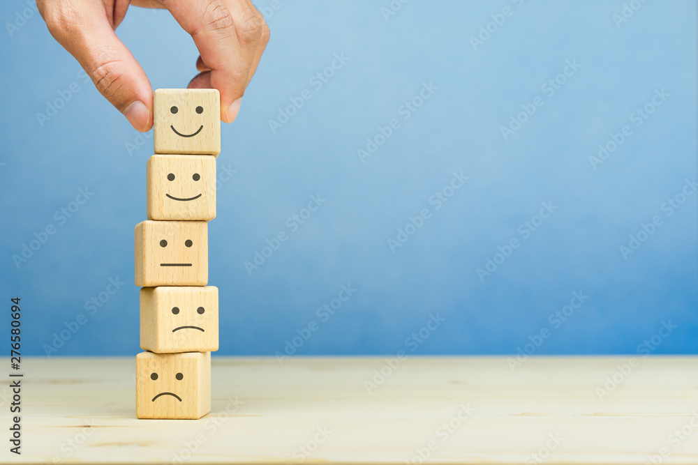 © Worawut - Customer service evaluation and satisfaction survey concepts. The client's hand picked the happy face smile face symbol on wooden blocks, copy space © Worawut - Customer service evaluation and satisfaction survey concepts. The client's hand picked the happy face smile face symbol on wooden blocks, copy space