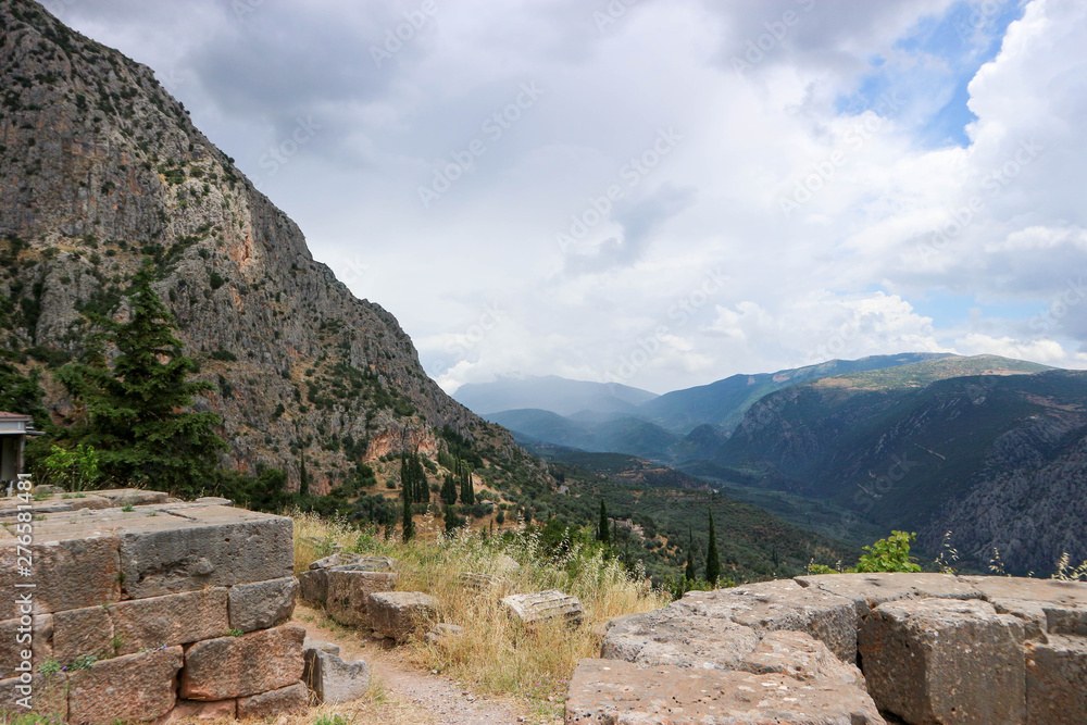 Ruins of ancient greek city Delphi with beautiful mountain landscape of Greece on the background