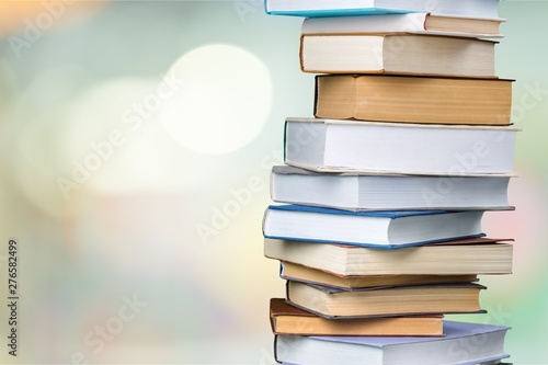 Ancient stack books on abstract bokeh background
