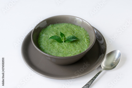 Vegetarian soup of broccoli puree on a white background. The concept of healthy eating.