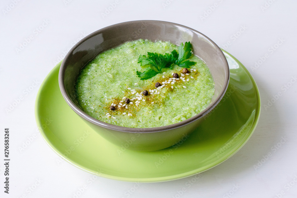 Vegetarian soup of broccoli puree on a white background. The concept of healthy eating.