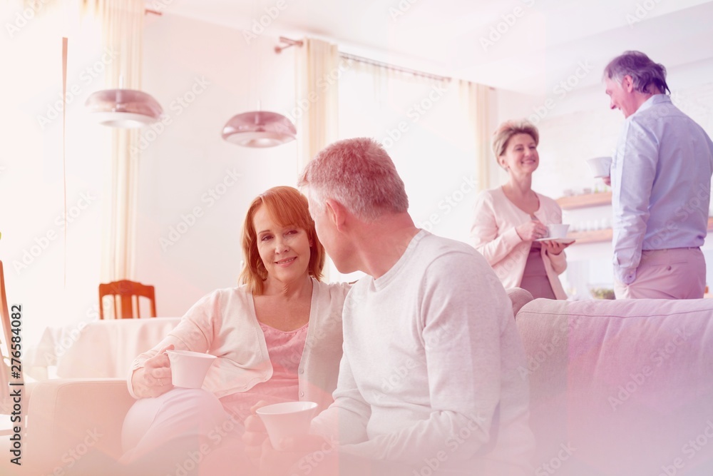Obraz premium Mature couples talking in living room at home