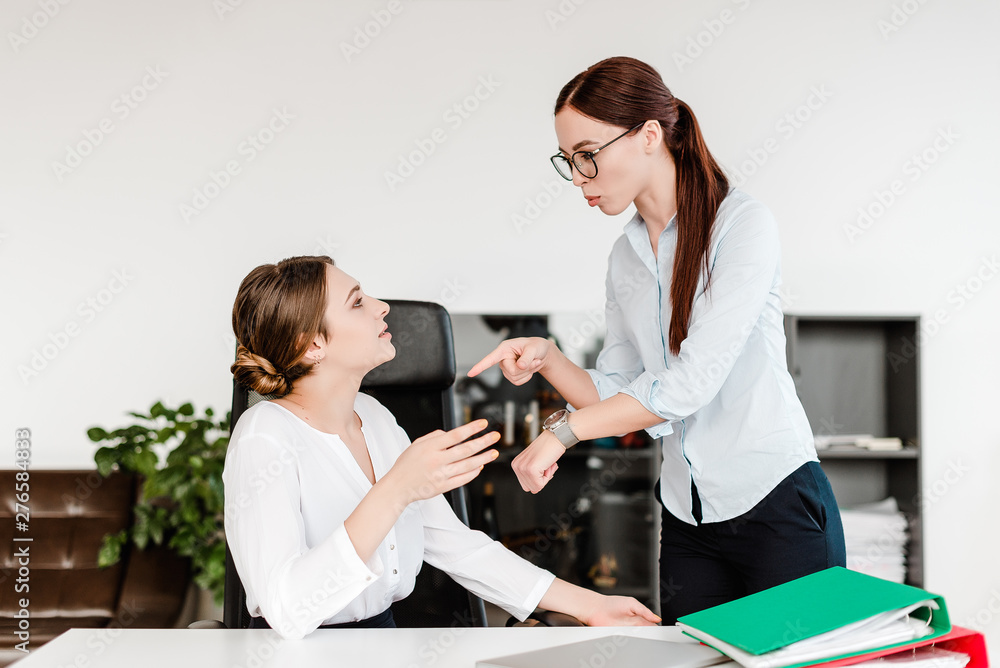 bossy woman teaches discipline to the employee in the office bossy woman teaches discipline to the employee in the office