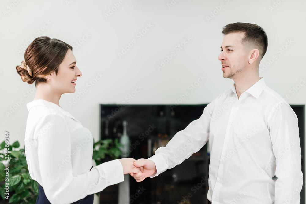 office workers cooperating and shaking hands on a deal office workers cooperating and shaking hands on a deal