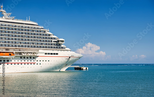 Luxury Cruise ship docked at port on sunny day