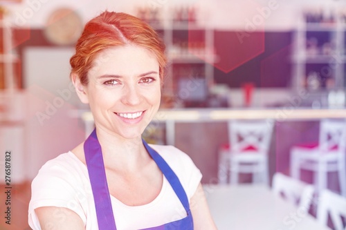 Free Download Closeup portrait of smiling young waitress standing at restaurant - GFXLoad