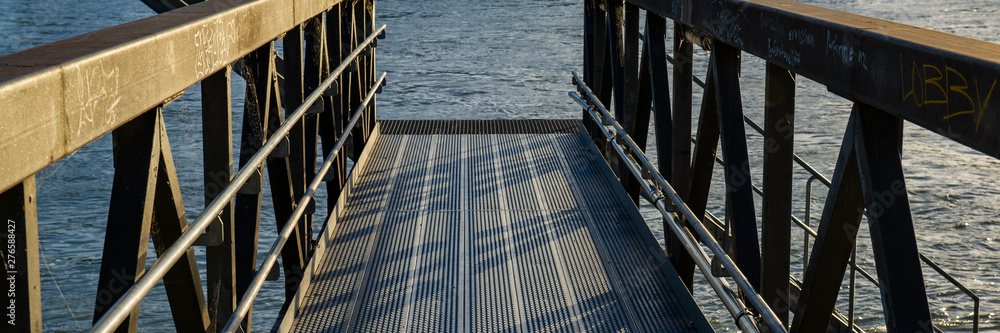 Obraz premium metal bridge for mooring of river vessels.