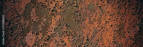 Rusty metal sheet surface coated with decaying paint.