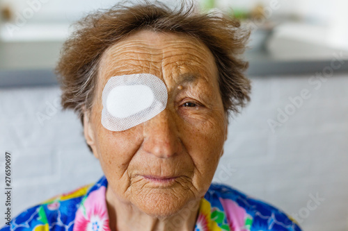 an old person with eye bandage photo