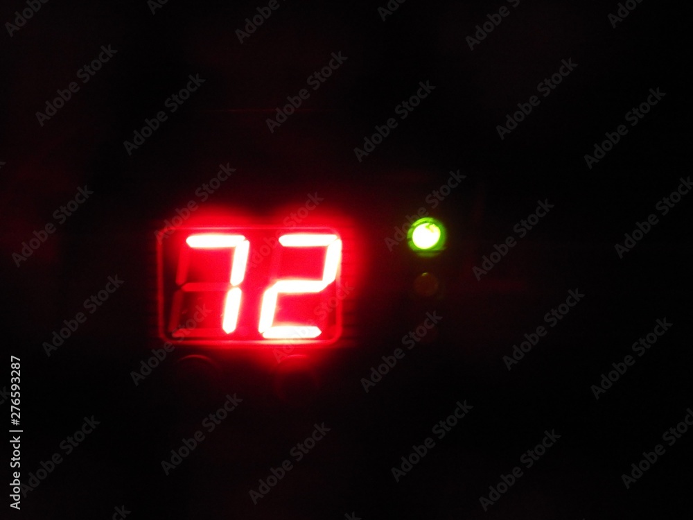 72 degrees digital indication in red with green dot on black