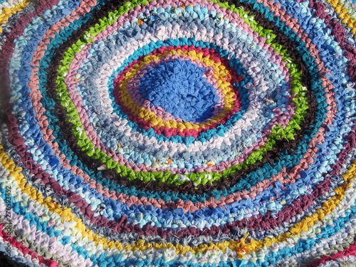 Hand-made knitted rug from strips of cloth colorful