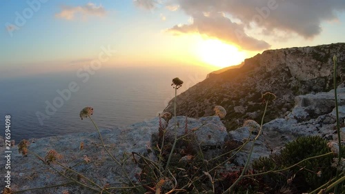 majestic sunset on Fawwara cliff Beautiful view over the mediterranean sea and vivid horizon, colorful sky with cloud formations timelapse photo