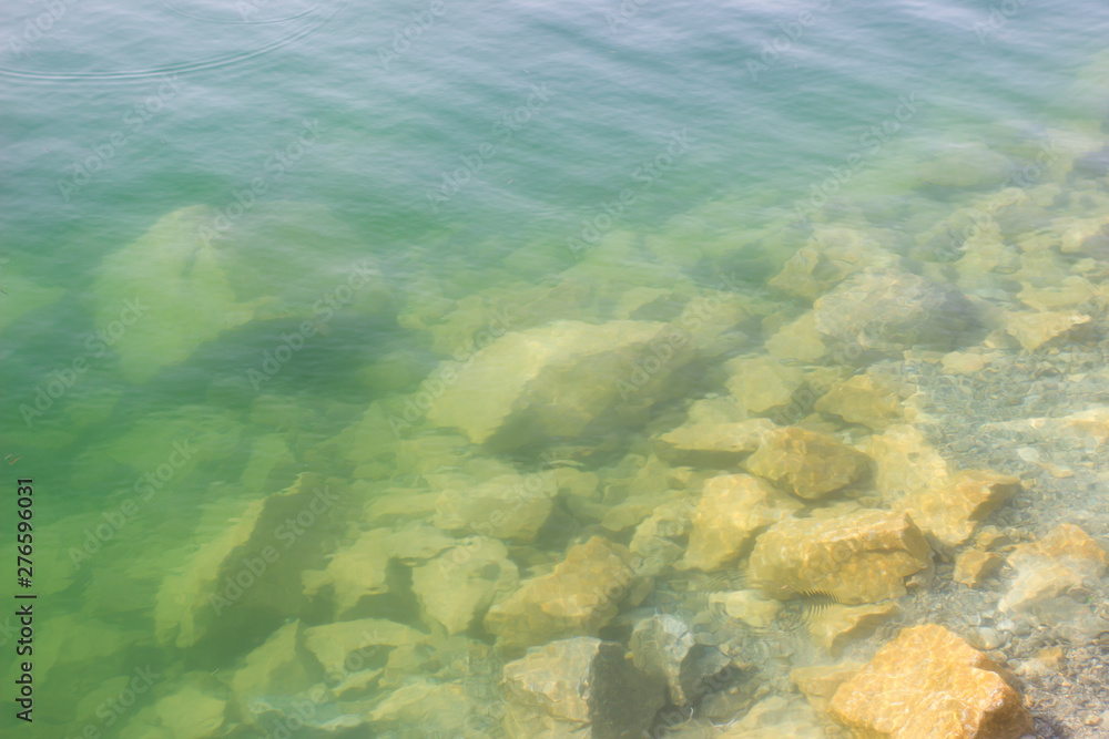 Texture of water surface sun water stones waves - underwater world