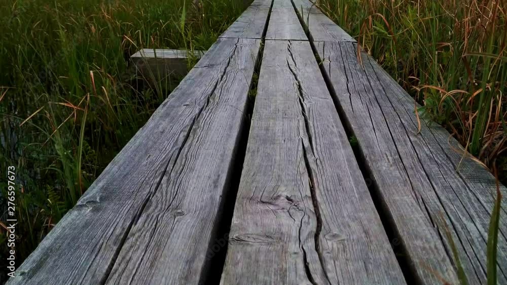 Wooden plank texture of narrow bridge to Kemeri National Park, close up follow shot Wooden plank texture of narrow bridge to Kemeri National Park, close up follow shot