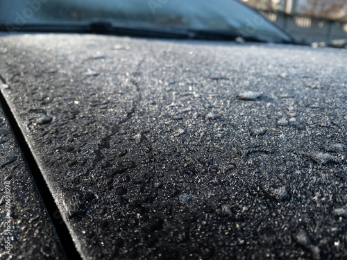 White frost on the car body. Small layer of snow