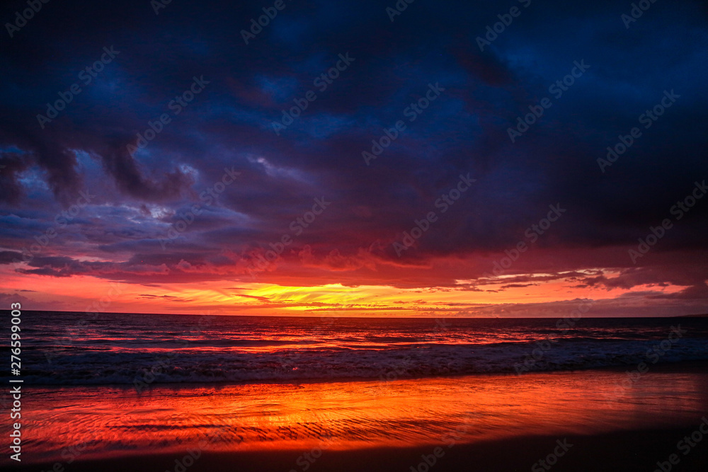 red sky with clouds in the beach