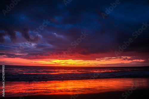 red sky with clouds in the beach