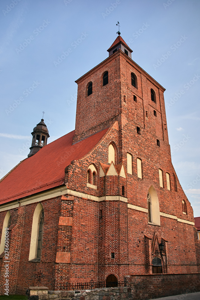 Fototapeta premium The facade of the gothic medieval Catholic Church with belfry of in Grudziadz.