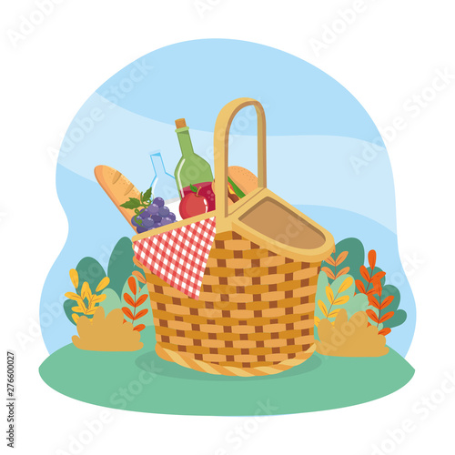 hamper with bread and wine bottle with grapes and hamburger