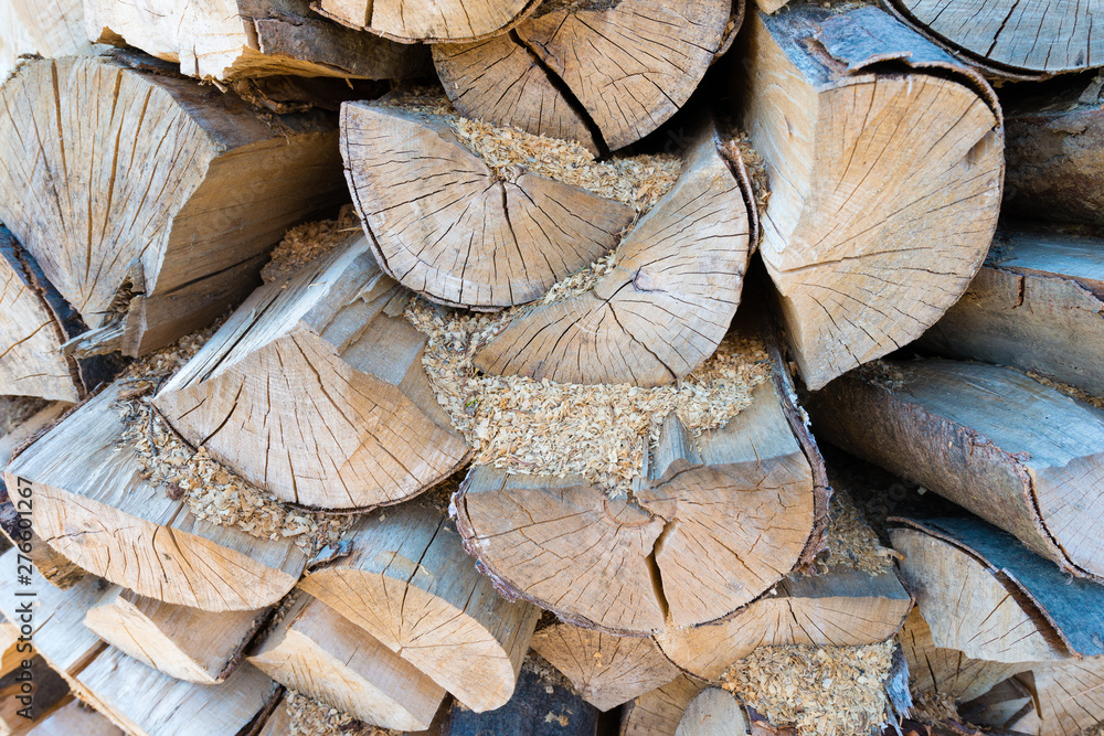 Naklejka premium Wall of stacked wood logs as background