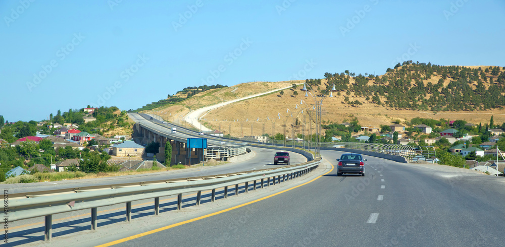 Yellow mountains. Road trip, fun car ride on desert mountain road in the western countryside. Bridge . The path to the car.