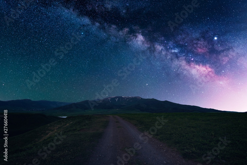 Beautiful night landscape. Starry sky with milky way galaxy over the road and Aragats mountain. Armenia.
