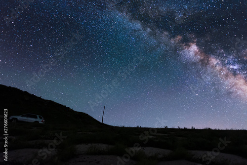 Beautiful night landscape. Starry night  and bright milky way galaxy over the hills.