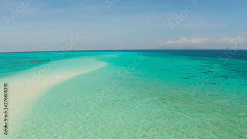 Island with a sandy beach and azure water surrounded by a coral reef and an atoll, aerial view. Mansalangan sandbar, Balabac, Palawan, Philippines. Summer and travel vacation concept