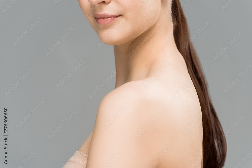 cropped view of happy young woman isolated on grey cropped view of happy young woman isolated on grey