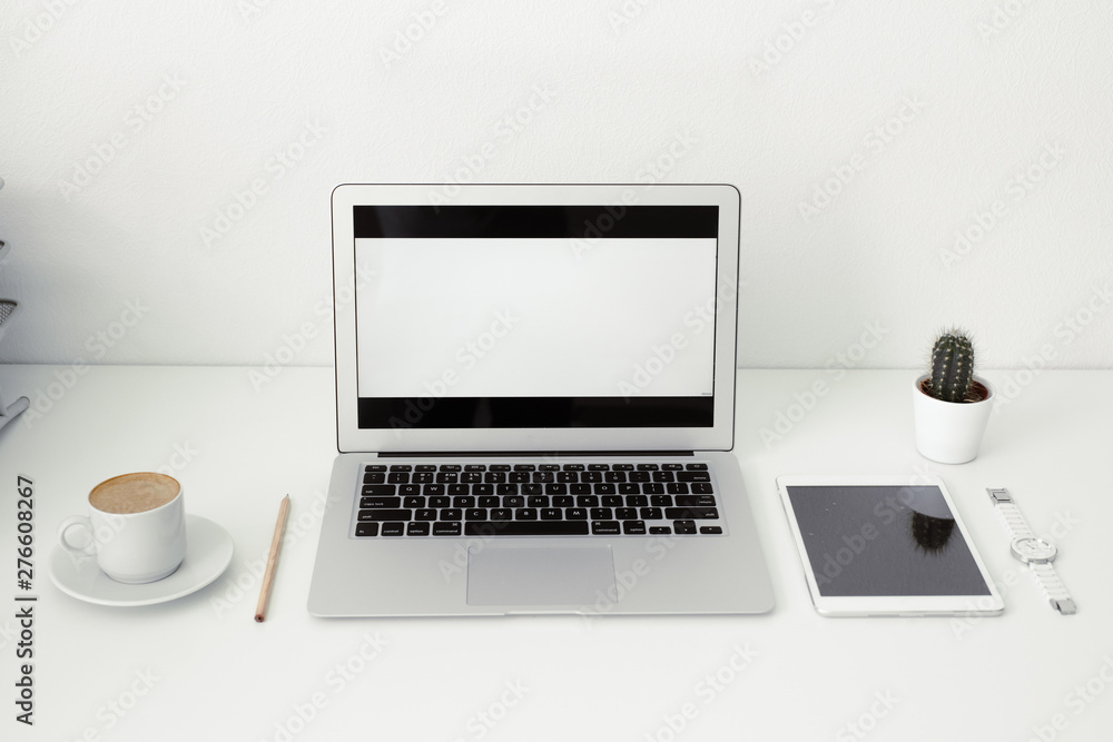 office table on which laptop, coffee, tablet, camera and other items office table on which laptop, coffee, tablet, camera and other items
