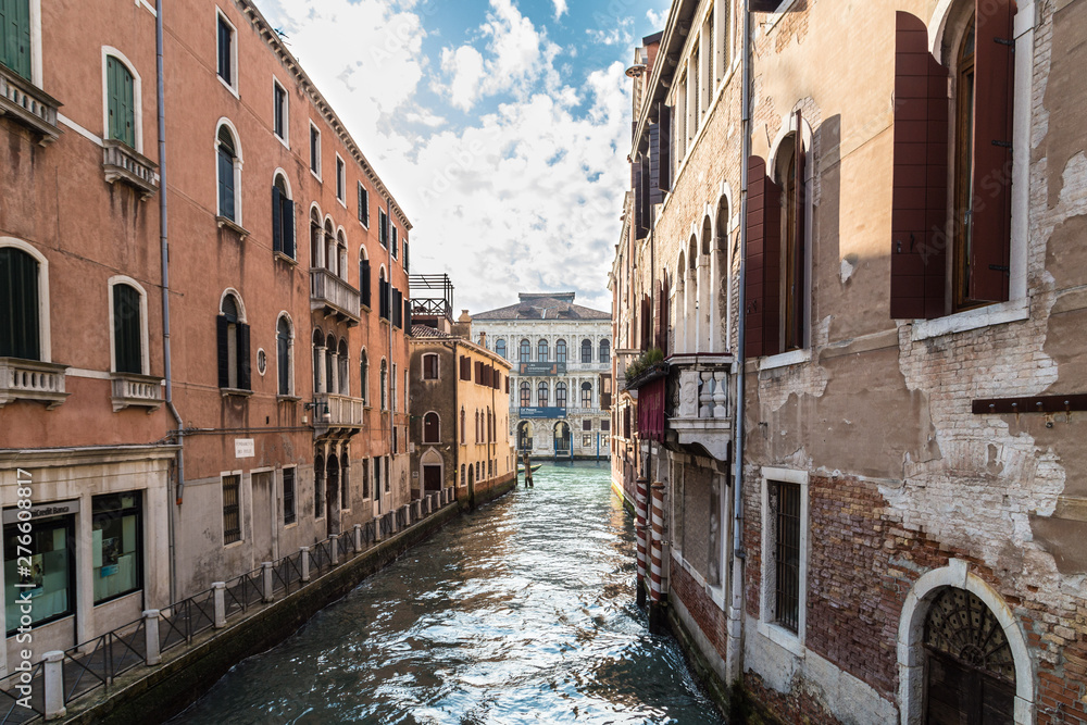 VENICE, ITALY - JAN 1, 2016: Water Canal of Venice, Italy. Narrow Streets of Venice. Water transportation, gondola, boats. Architecture buildings of Italy.