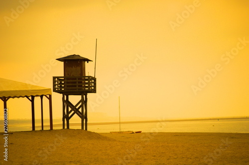 A lifeguard tower in a deserted beach of Huelva on a hot sunny day of summer, Spain 