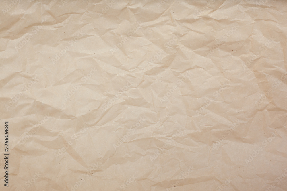 Fototapeta premium Pale brown crumpled paper texture background. Abstract pattern