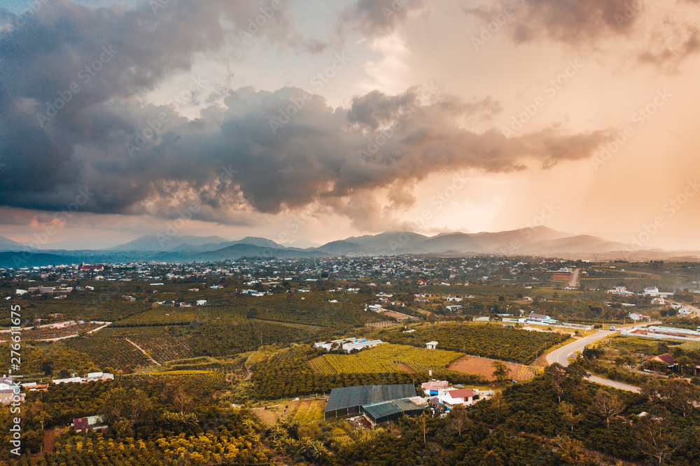 Aerial view of a sunset with orange sky over mountains in Bao Loc, Vietnam