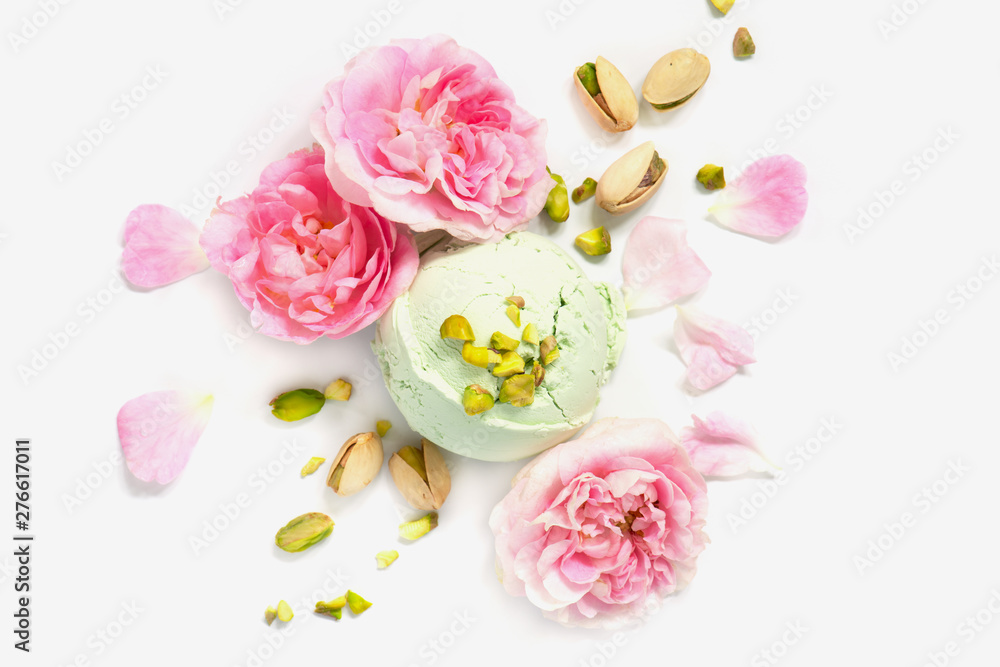 Plakat Ball of pistachio ice cream decorated with fresh pink roses
