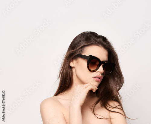sunglasses girl, close up studio shot of beautiful fashion young woman model with long hair looking at camera . while posing against clean white blank copy space wall for your content © Dave Studio