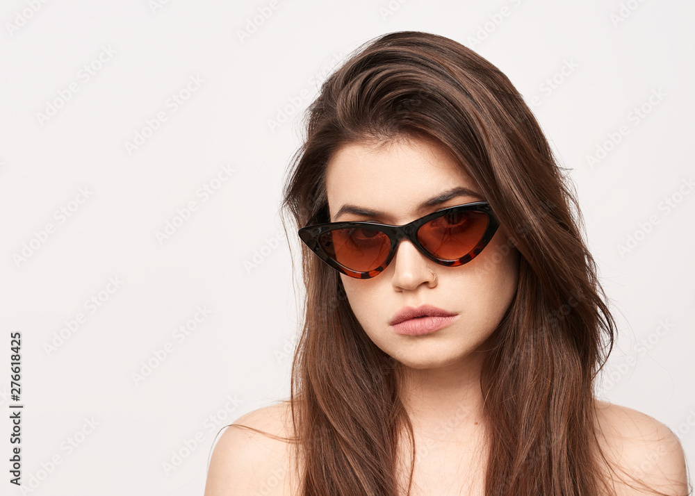 sunglasses girl, close up studio shot of beautiful fashion young woman model with long hair looking at camera . while posing against clean white blank copy space wall for your content sunglasses girl, close up studio shot of beautiful fashion young woman model with long hair looking at camera . while posing against clean white blank copy space wall for your content