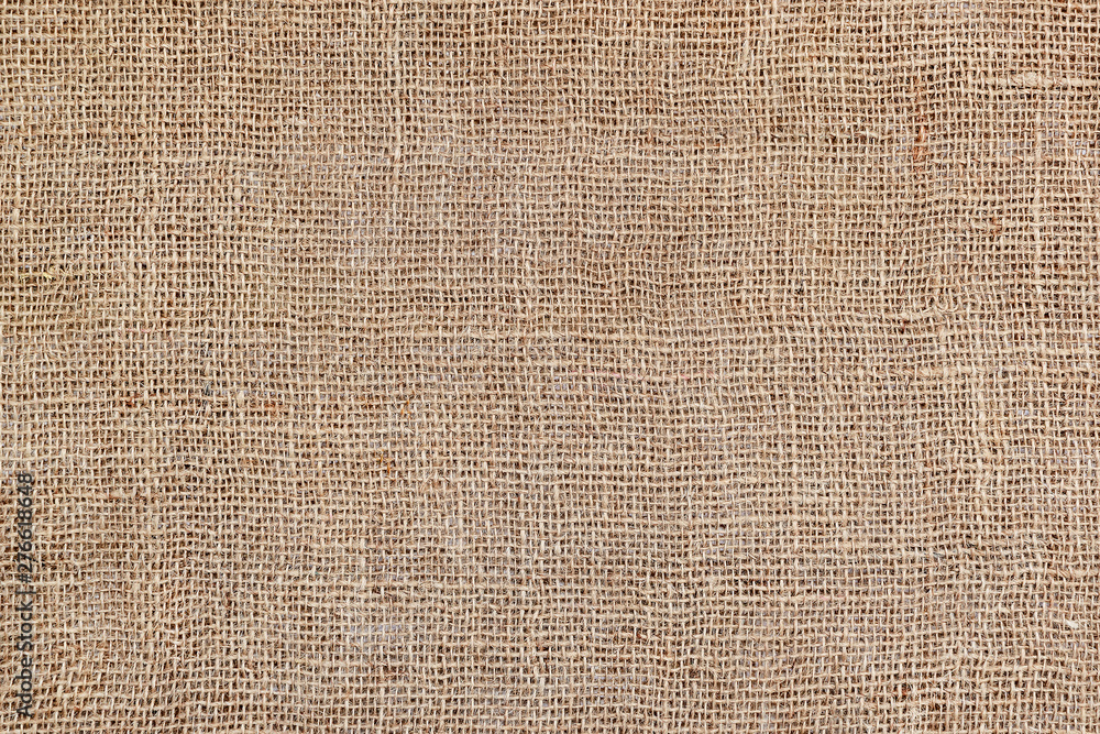 Rural texture of sackcloth. Background of very coarse, rough fabric woven made of flax, jute or hemp. Burlap bag material. Design element. Sacking and bagging pattern. Rural texture of sackcloth. Background of very coarse, rough fabric woven made of flax, jute or hemp. Burlap bag material. Design element. Sacking and bagging pattern.