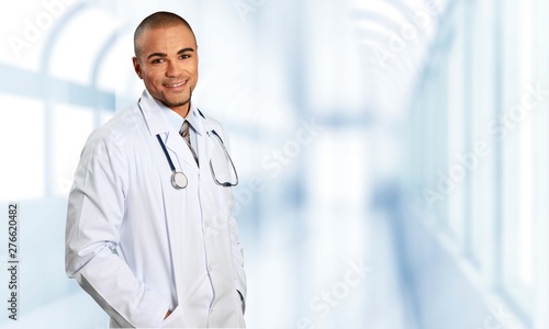 Young beautiful nurse on blurred hospital background