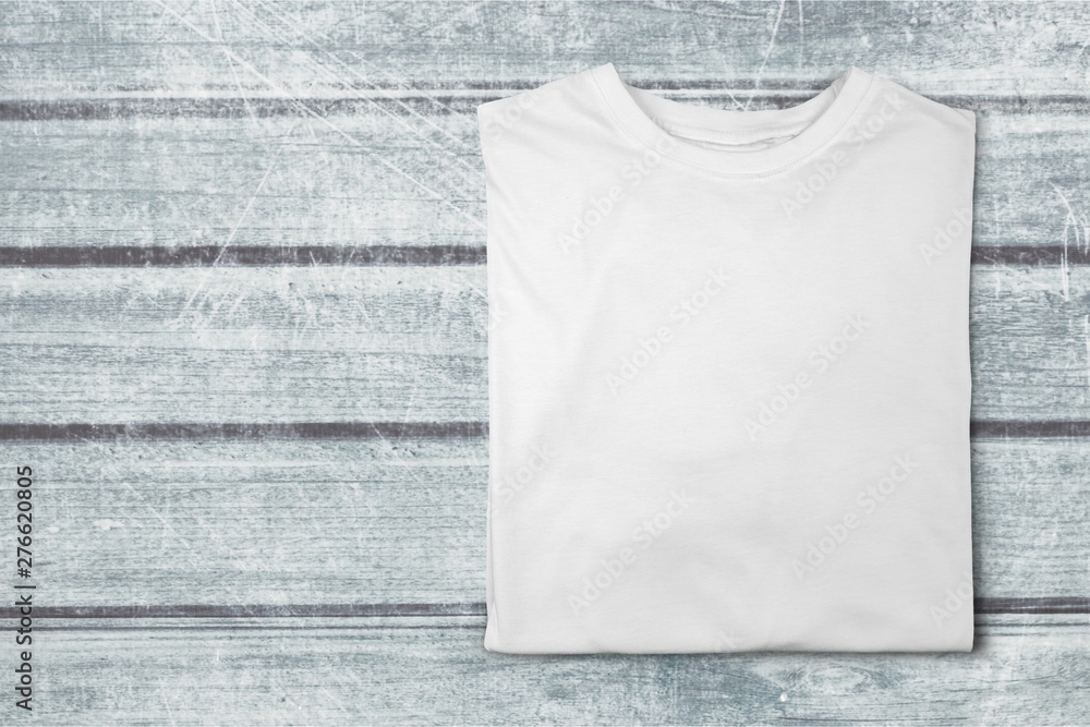 Top view of white T-Shirt on wooden background Top view of white T-Shirt on wooden background