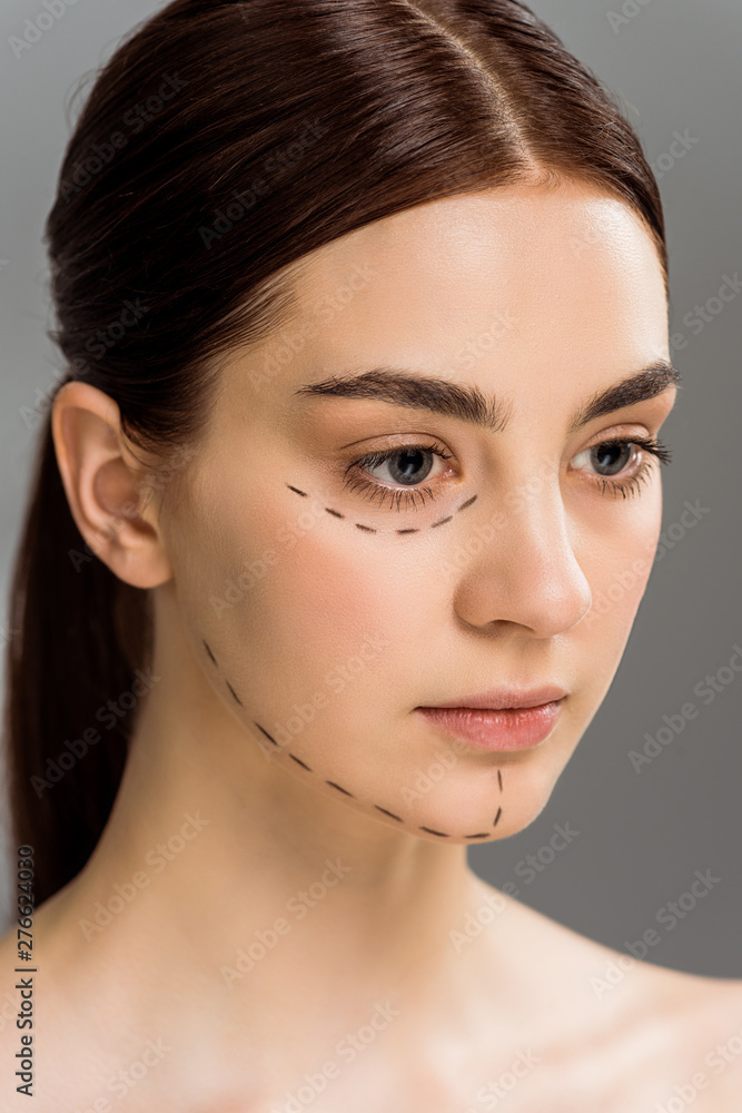 Fototapeta premium beautiful young woman with marks on face isolated on grey
