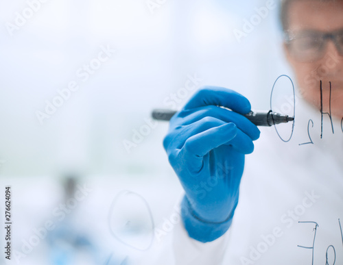 background image.scientist making notes on a transparent Board