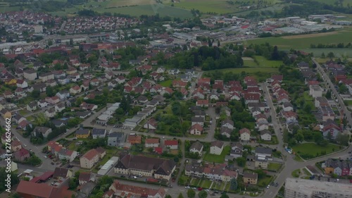 Aerial of small town Eppingen in Germany on sunny day in Spring. Zoom out with pan to the rightt across end of town. photo