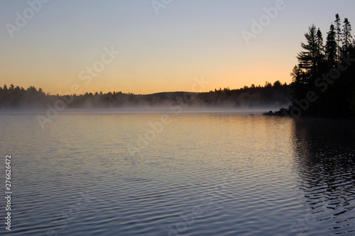 Sunrise and mist in beautiful lake in Algonquin Park.