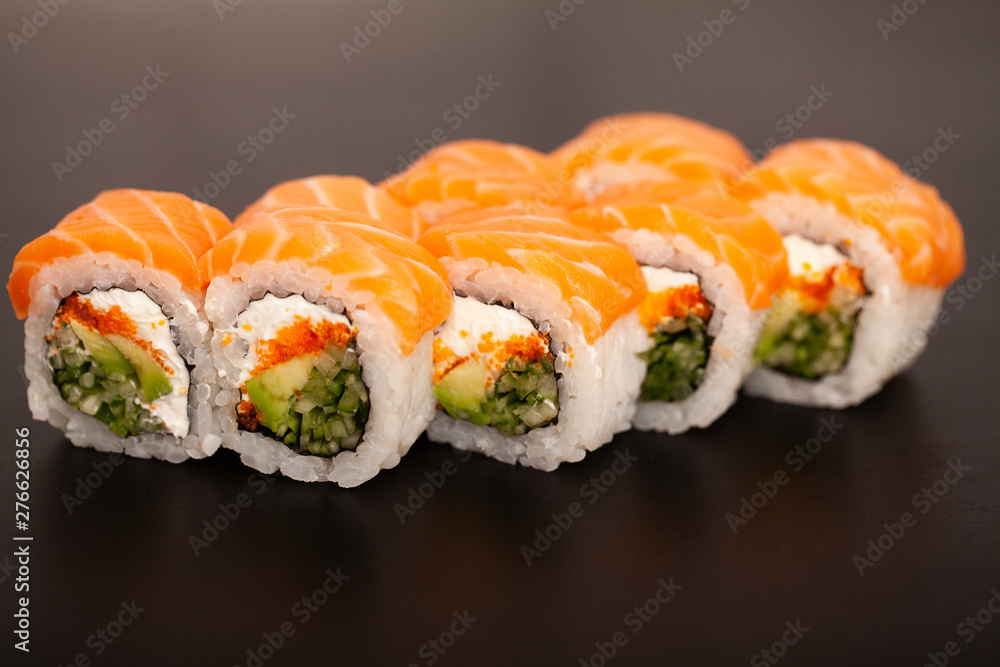 Sushi roll with salmon, cheese and avocado. Sushi roll with salmon, cheese and avocado.