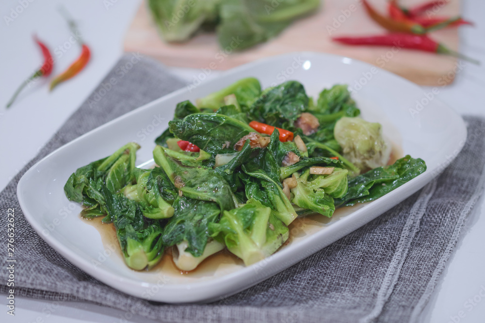 Stir-fried Brussels sprout with sun-dried crispy fish on the plate. Stir-fried Brussels sprout with sun-dried crispy fish on the plate.