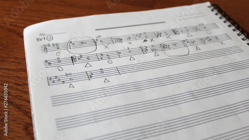 Handwritten musical notes, music theory exercise on paper